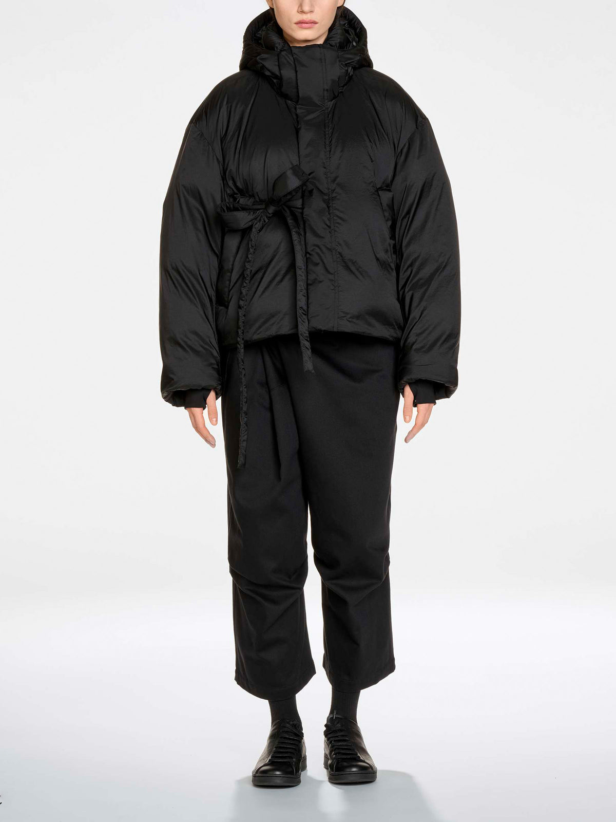Y-3 Hooded Puffer Jacket in Black - full length front view on model showing oversized silhouette and belted waist