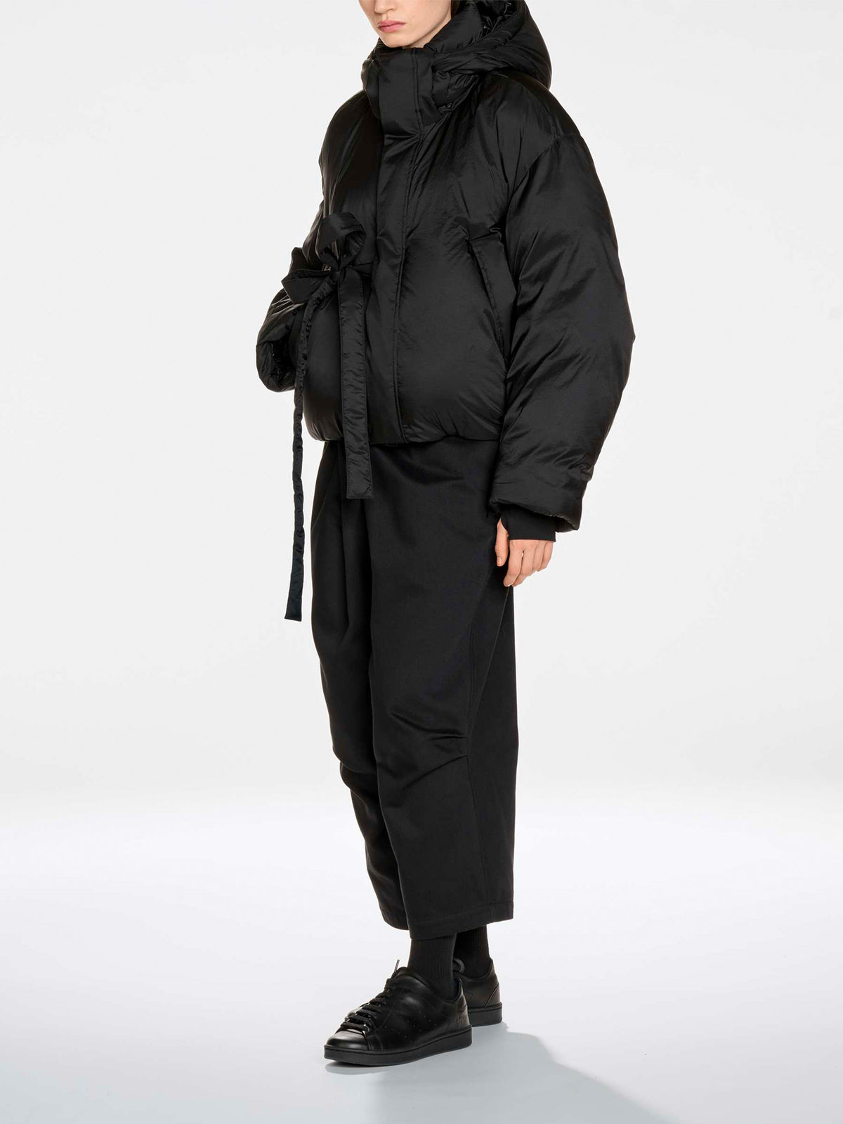Y-3 Hooded Puffer Jacket in Black - three-quarter view on model showing belted waist and relaxed fit