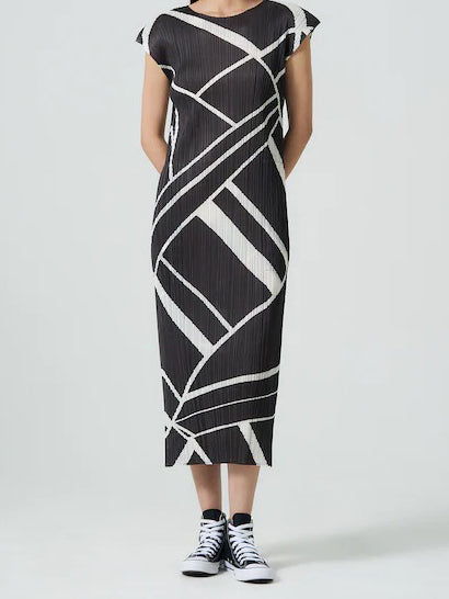 Pleats Please Issey Miyake Fold Line Dress in Charcoal, worn view showing pleated midi silhouette, cap sleeves and geometric fold line pattern