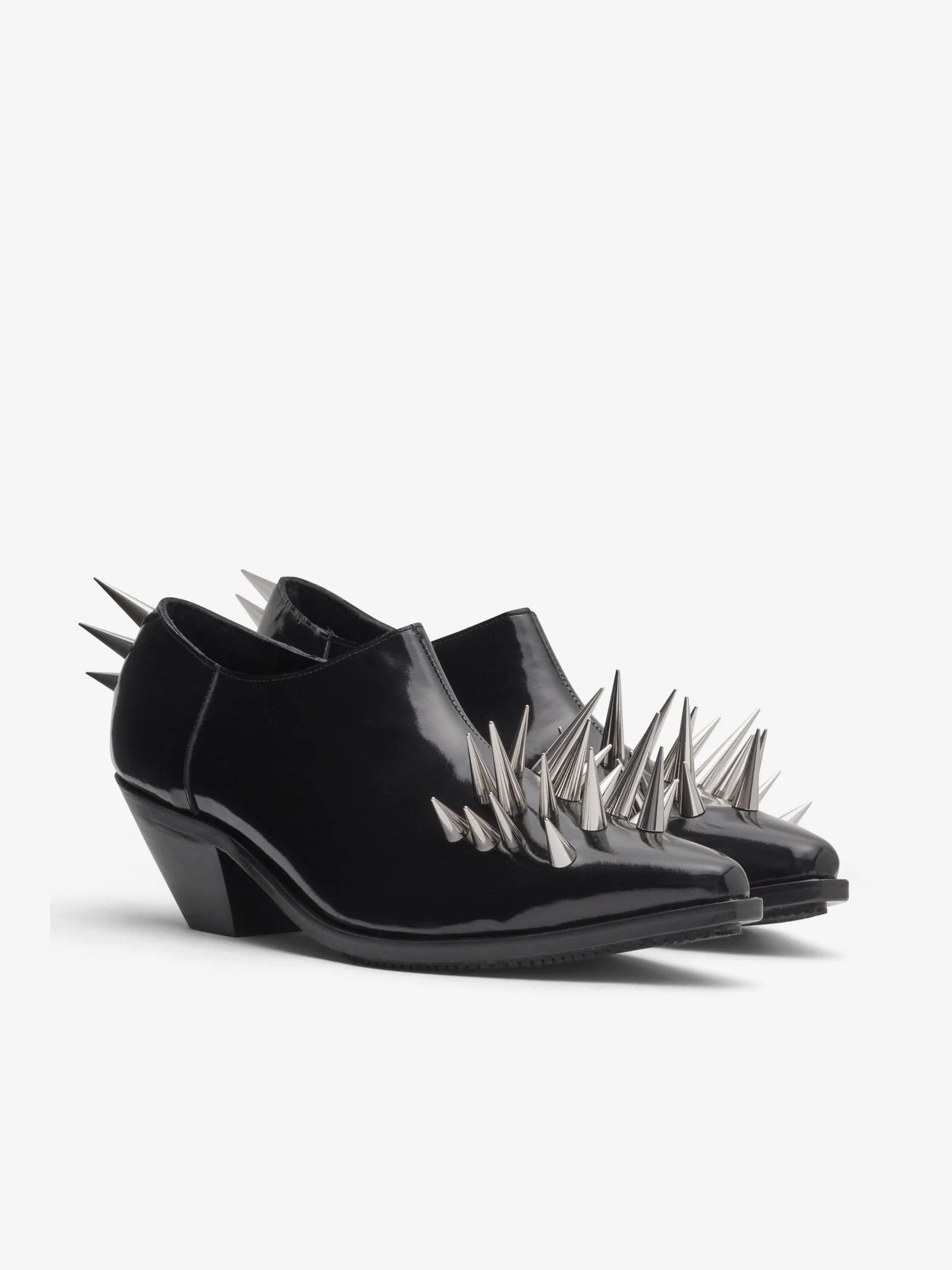 Junya Watanabe Women's Spiked Leather Shoes in Black, angled view showing the side zip closure, pointed toe and metallic spike detailing.