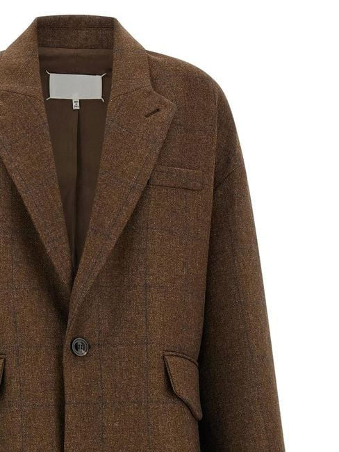 Close-up of the Maison Margiela Oversized Cocooning Coat in Brown, showing the structured wool texture, lapel, chest pocket and front flap pocket.