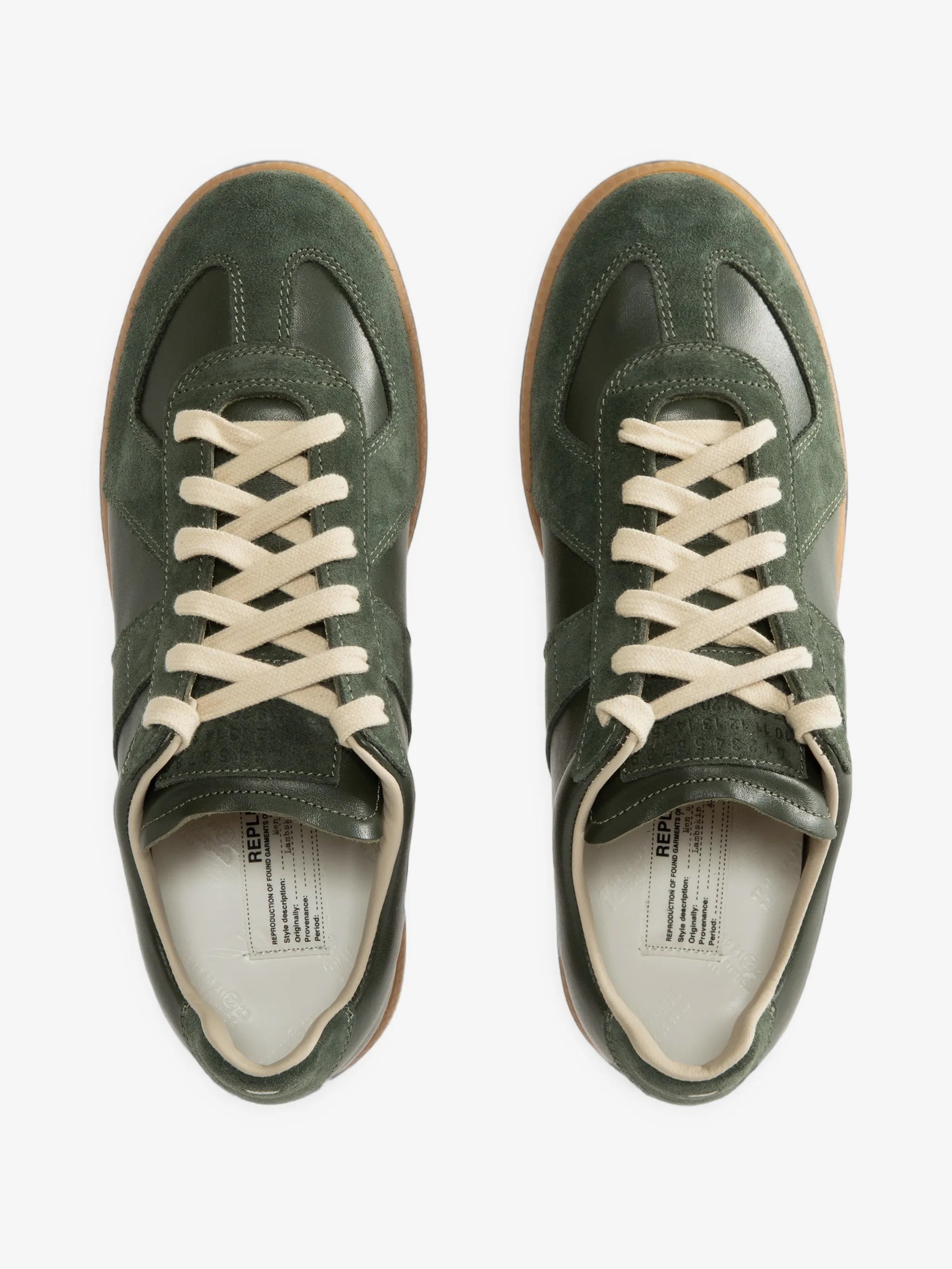 Top view of a pair of forest green Replica sneakers from Maison Margiela on a white background