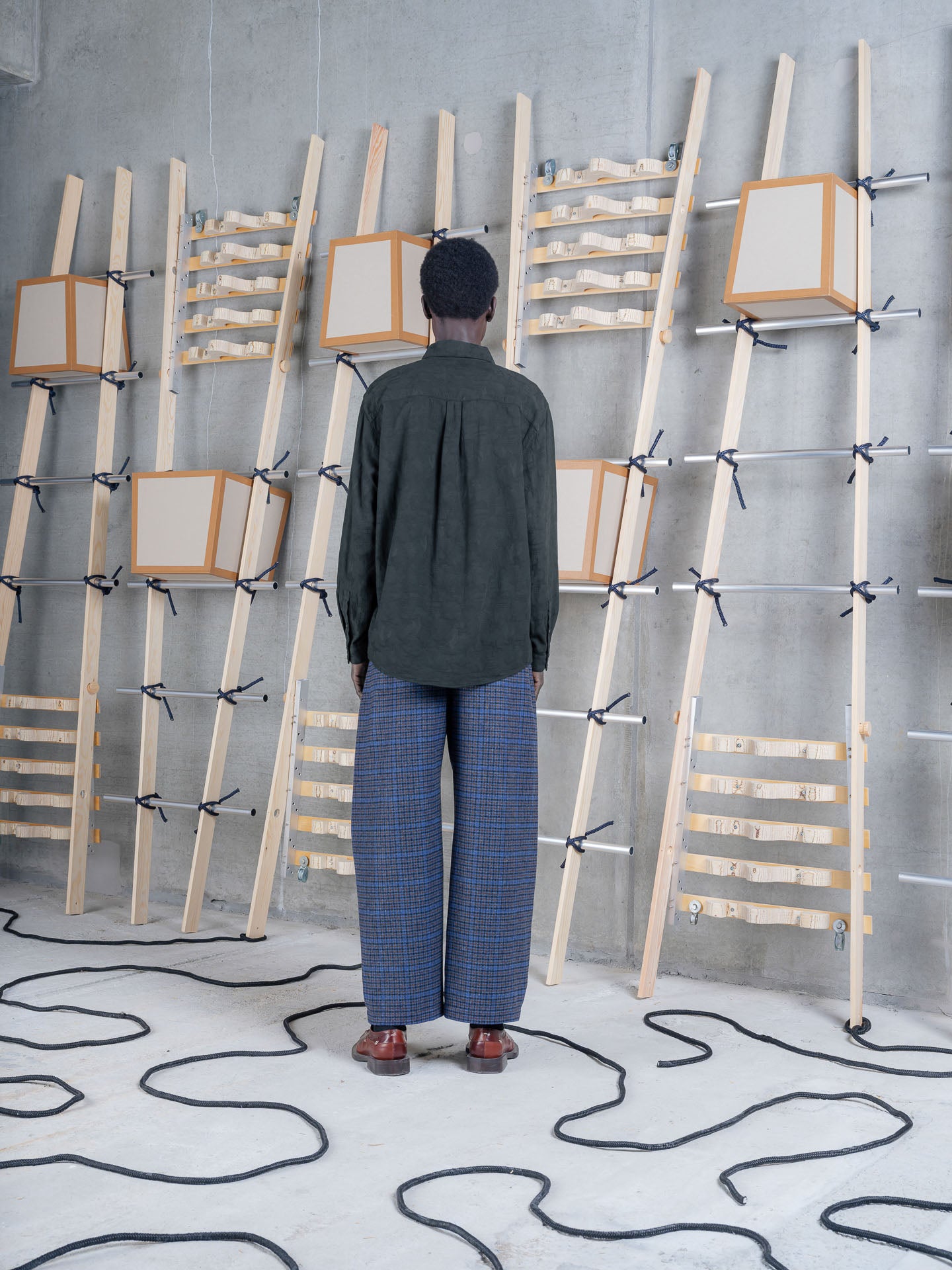 Model wearing Henrik Vibskov One Pants in Blue Wool Checks back view
