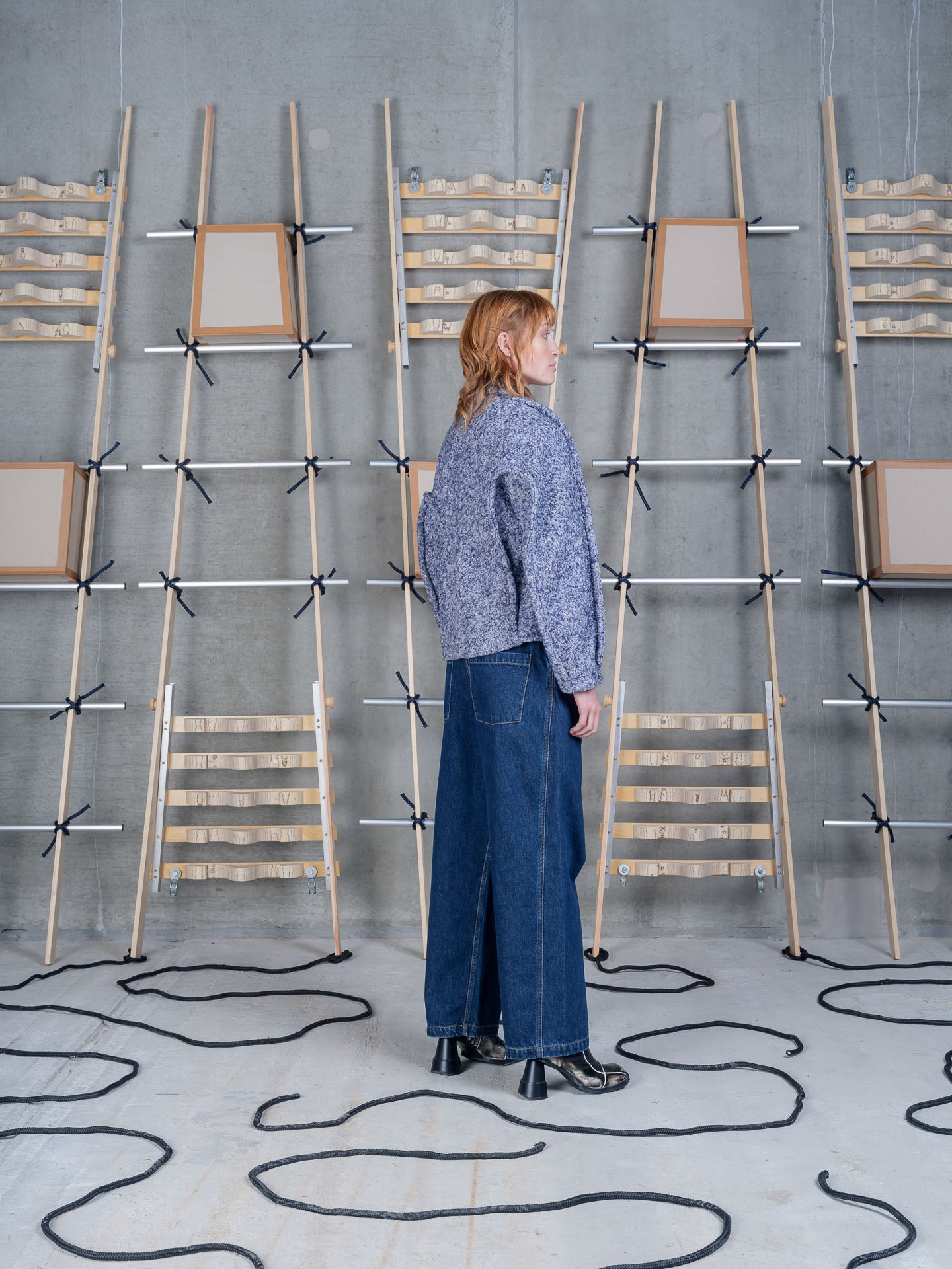 Model wearing Relaxed Dartbi Jacket in Blue Pebbles by Henrik Vibskov rear three-quarter view
