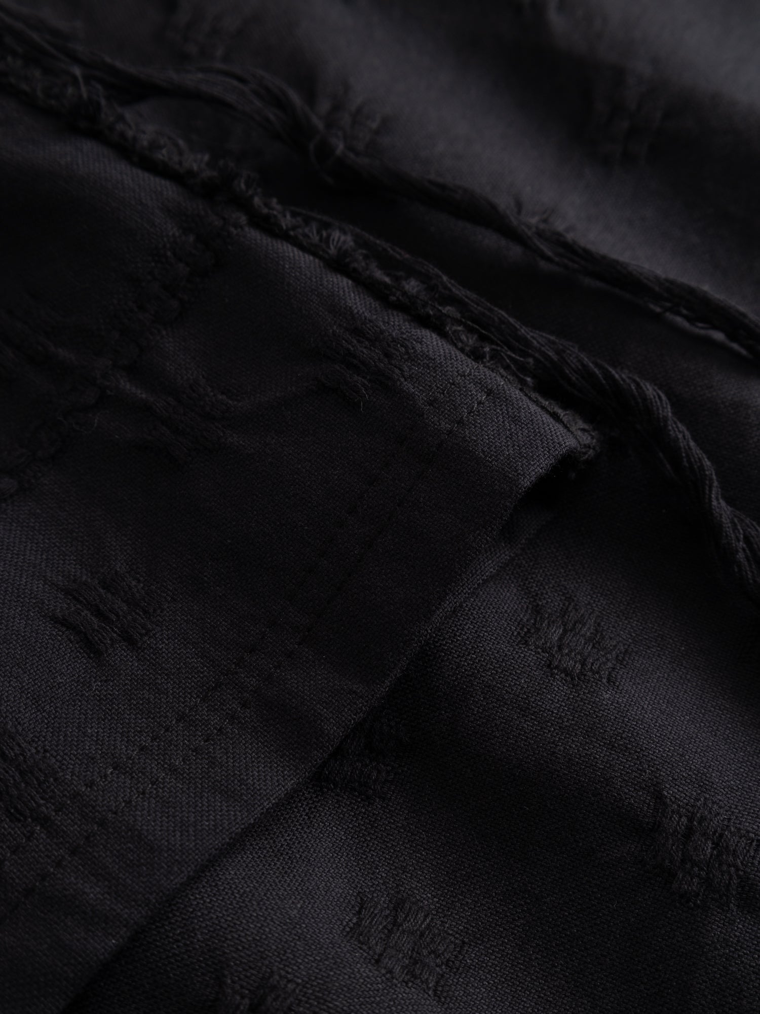 Stem Flower Tee in black, close-up of zero-waste woven floral jacquard construction and Tencel thread detail