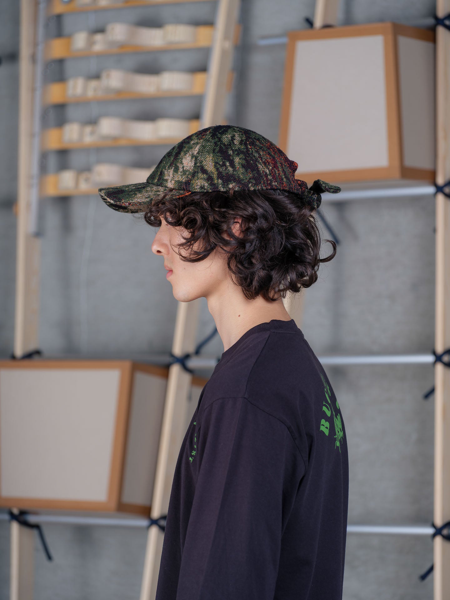 Model wearing Sausage Cap in Gobelin Swamp by Henrik Vibskov side view