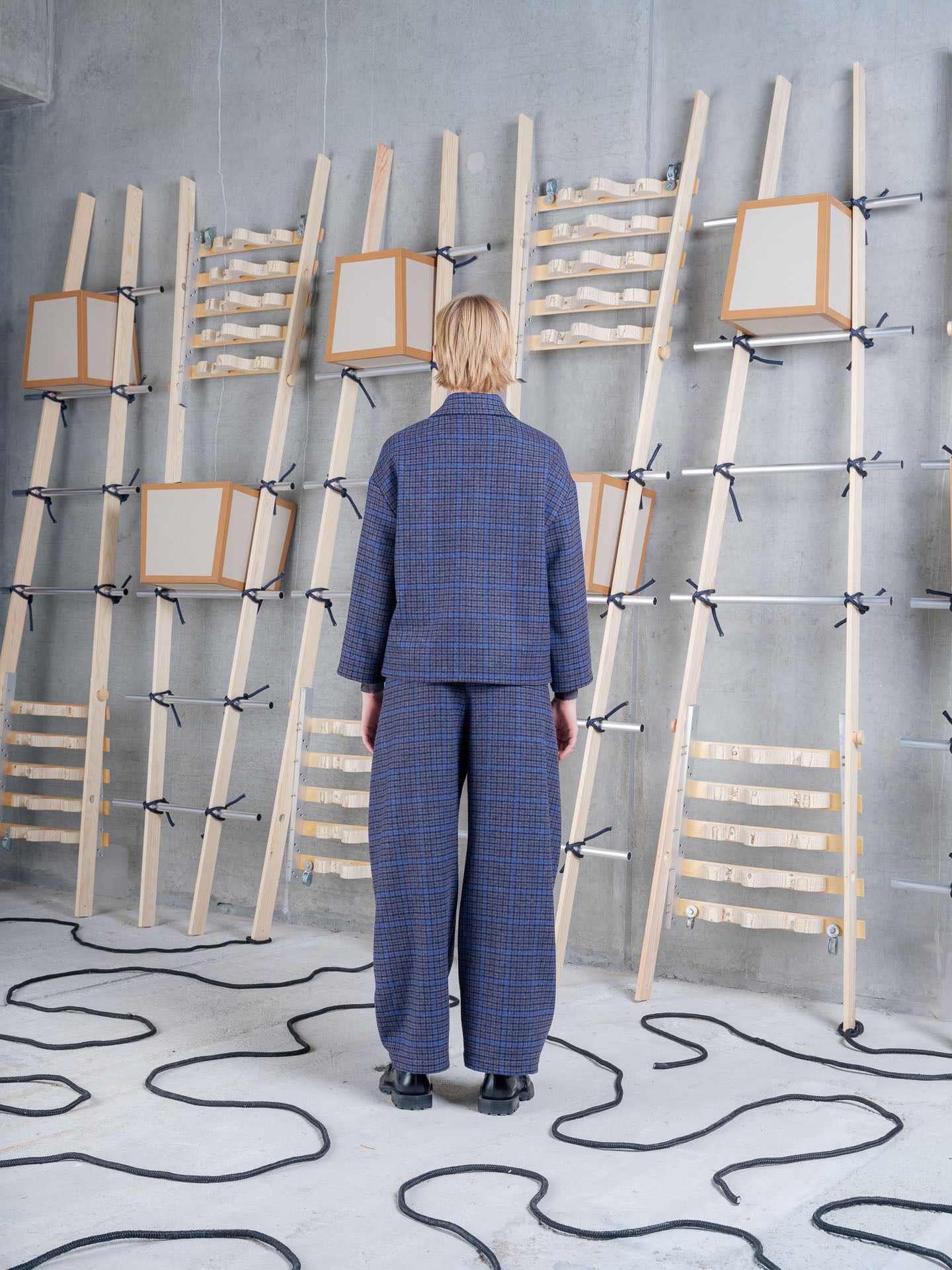 Back view of Henrik Vibskov Shady Suit Jacket in Blue Wool Checks styled with the matching trousers.