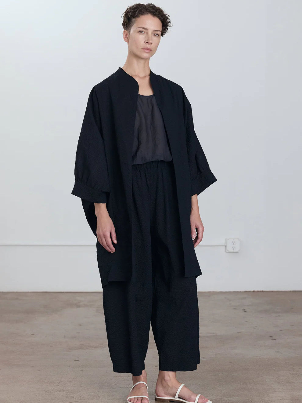 Black Crane Spoon Jacket in Midnight - full length front view on model showing oversized silhouette and long panelled front pockets