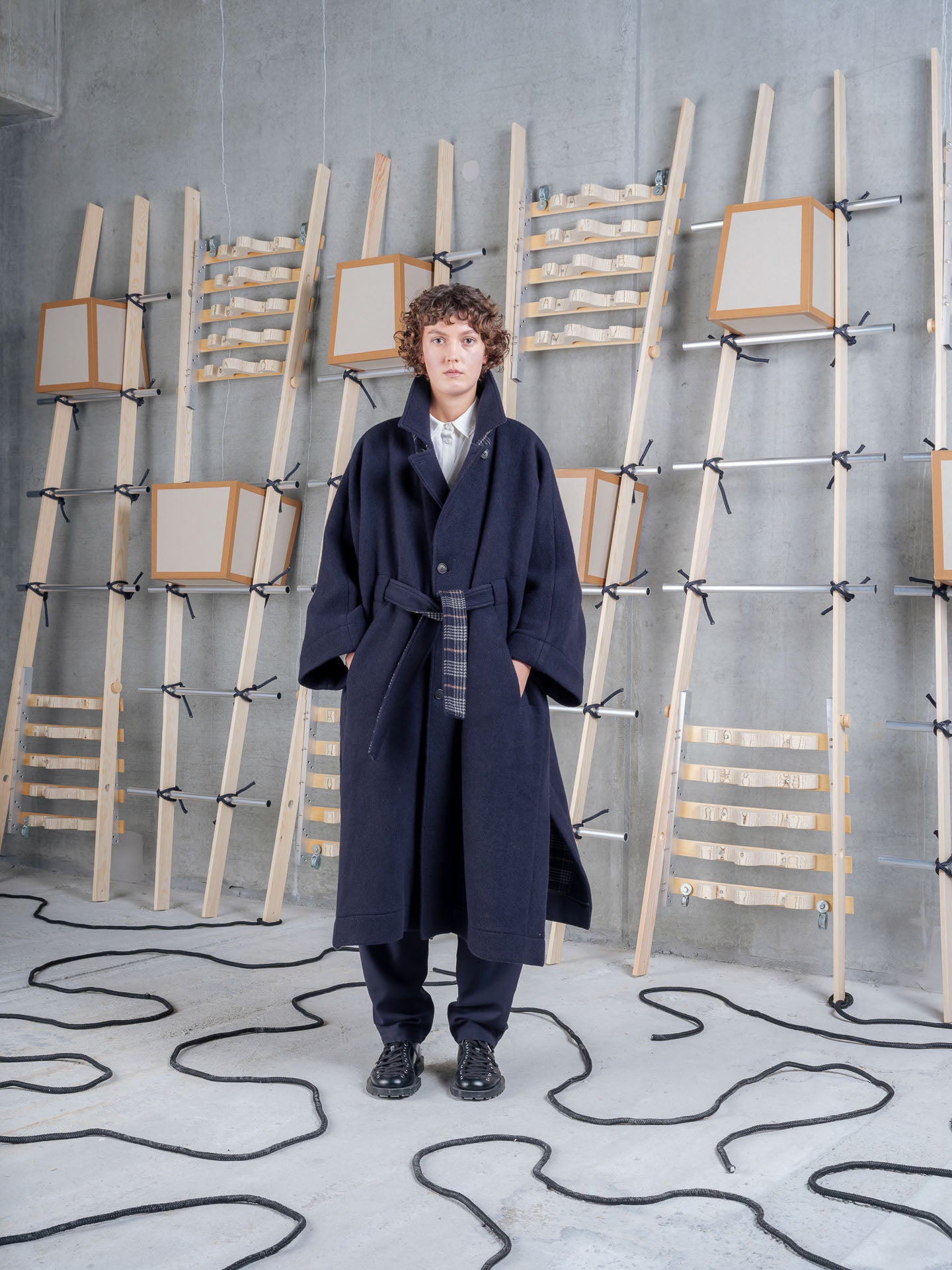 Model wearing Henrik Vibskov Toadcoat in Navy Duffle front three-quarter view
