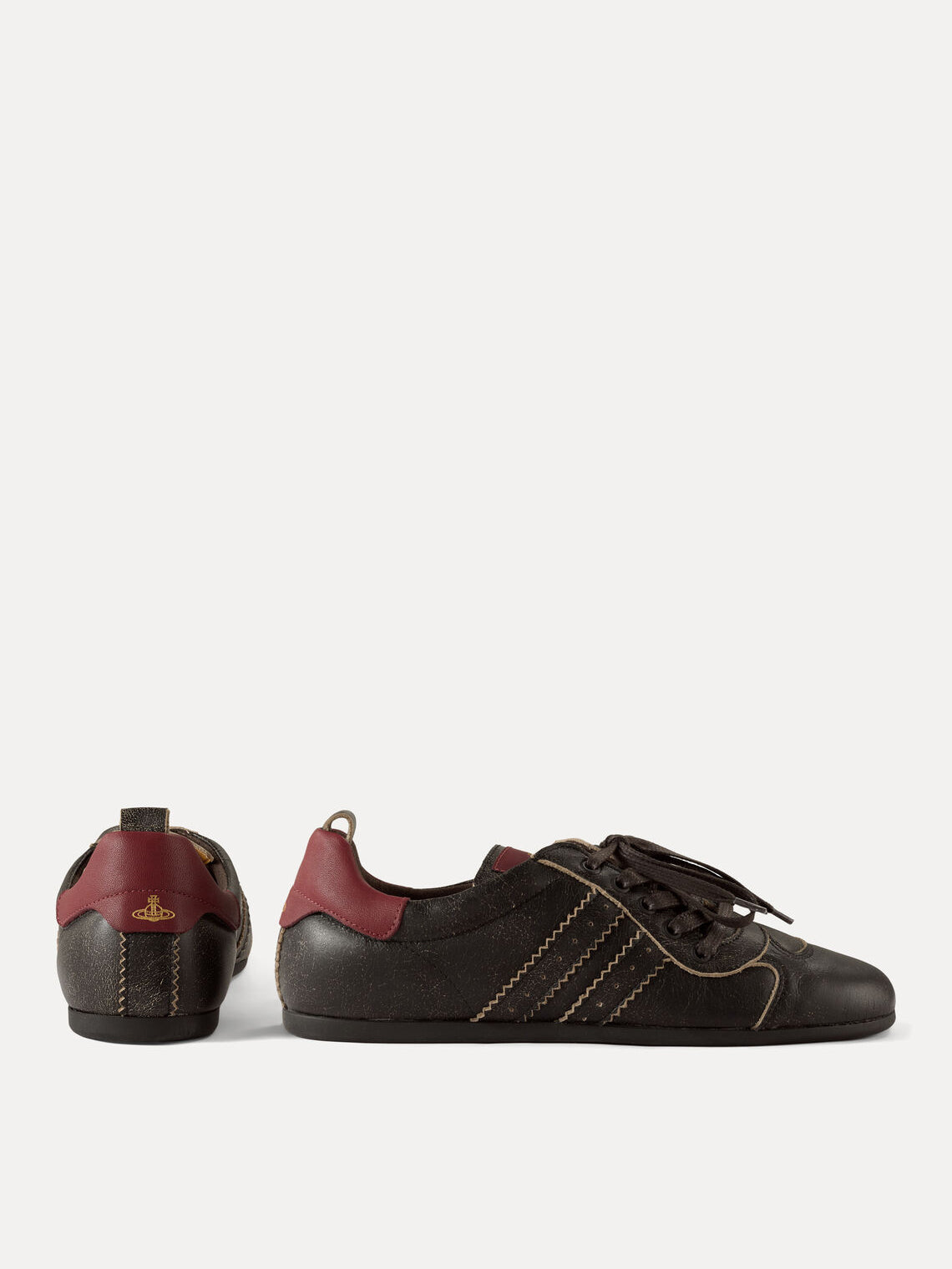 Side and heel view of Vivienne Westwood Drunken Trainers in Off Black with burgundy heel panels and gold-tone orb detail