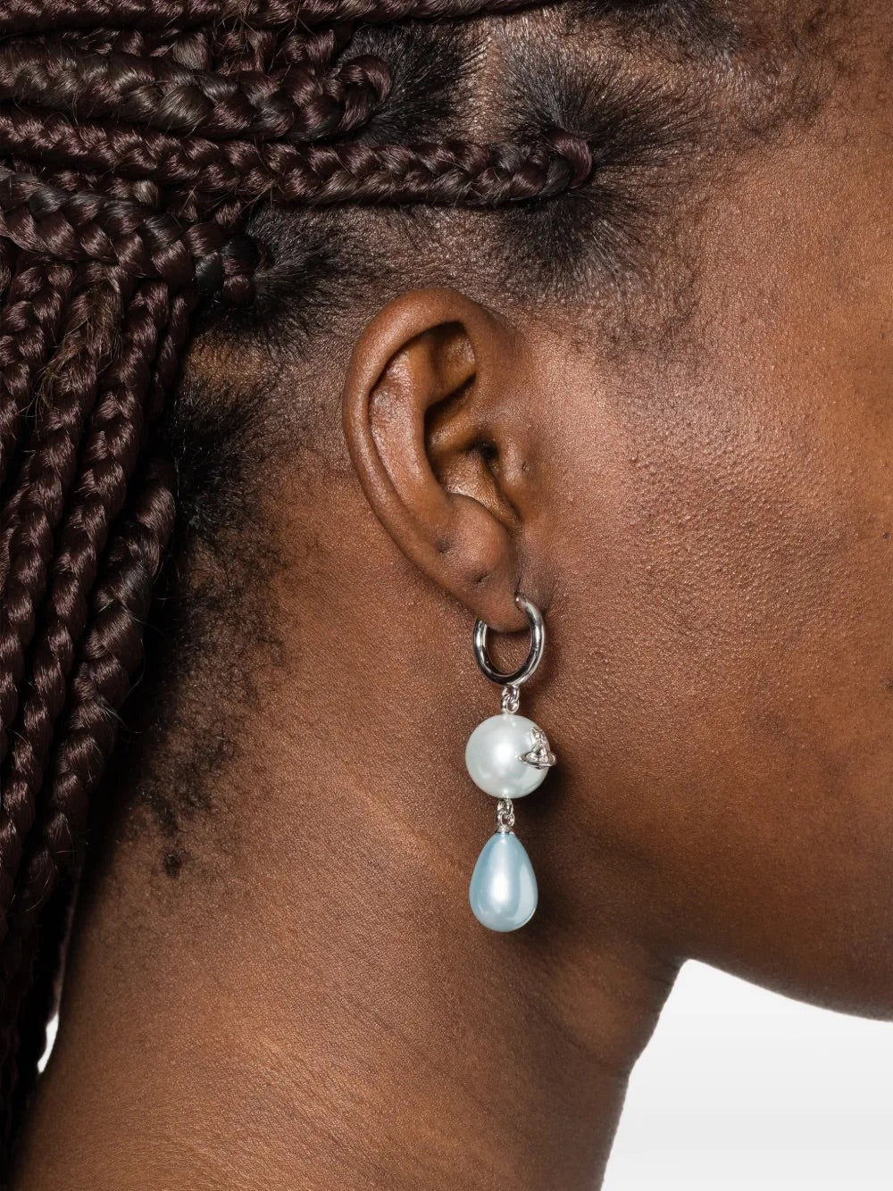 Model wearing Martha Earrings in Platinum/Light Blue by Vivienne Westwood, side profile showing silver-tone hoop earring with small white pearl and light blue teardrop resin pearl drop, 5.5cm drop length, Spring/Summer 2026