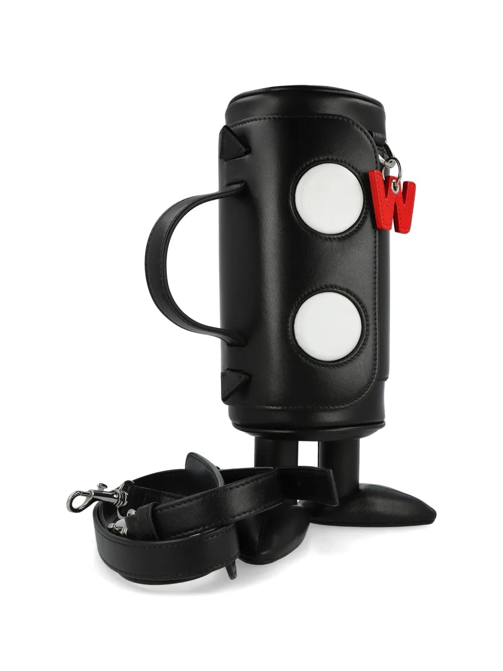 My Cilinder Friend Bag in Comb. I Black by Walter Van Beirendonck, front view of black leather cylindrical bag standing on two sculptural rounded feet, white circle appliques, red logo charm, top handle and detachable shoulder strap, zip closure