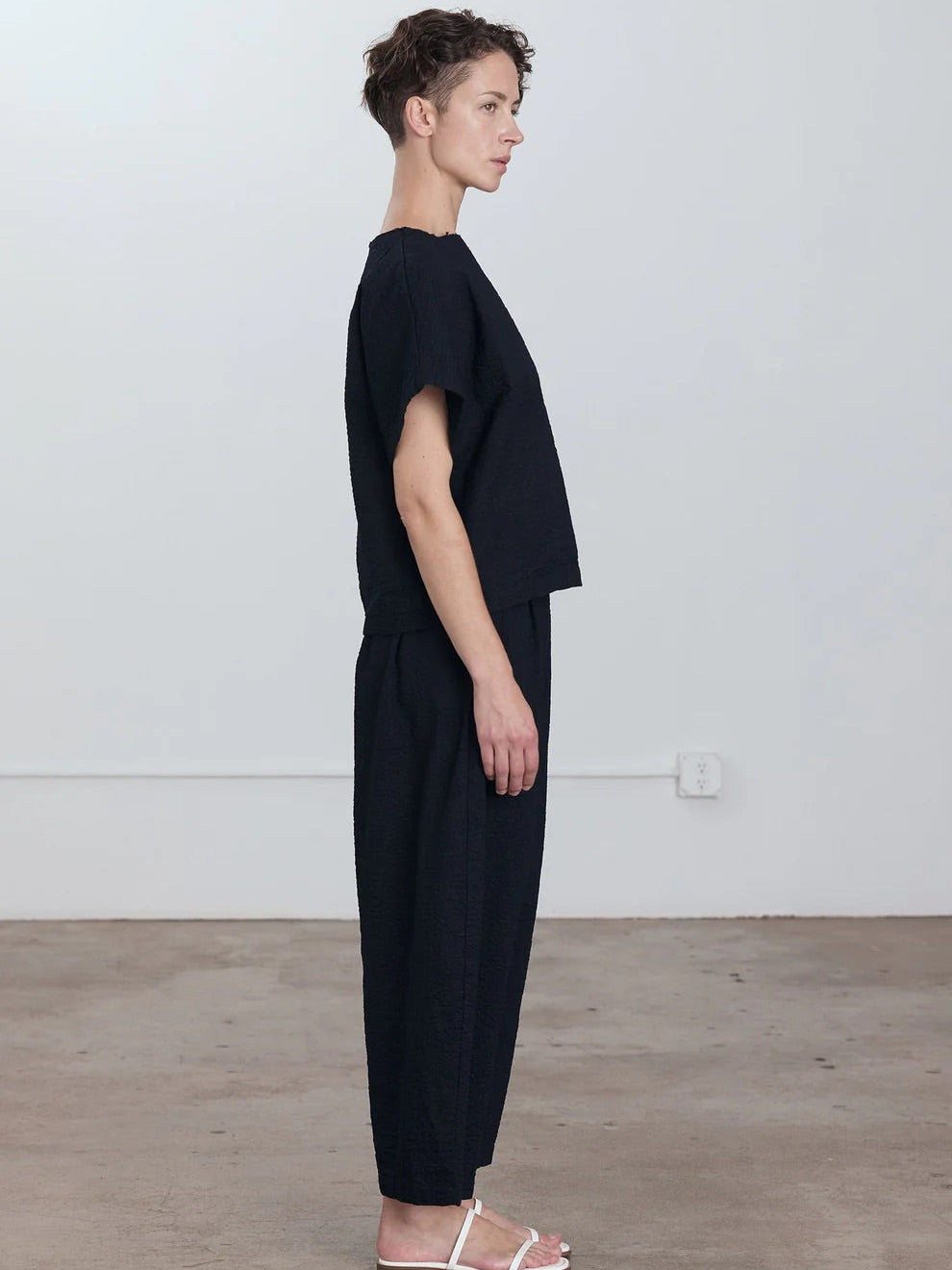 Black Crane Wide Pants in Midnight - side view on model showing wide leg silhouette and relaxed fit