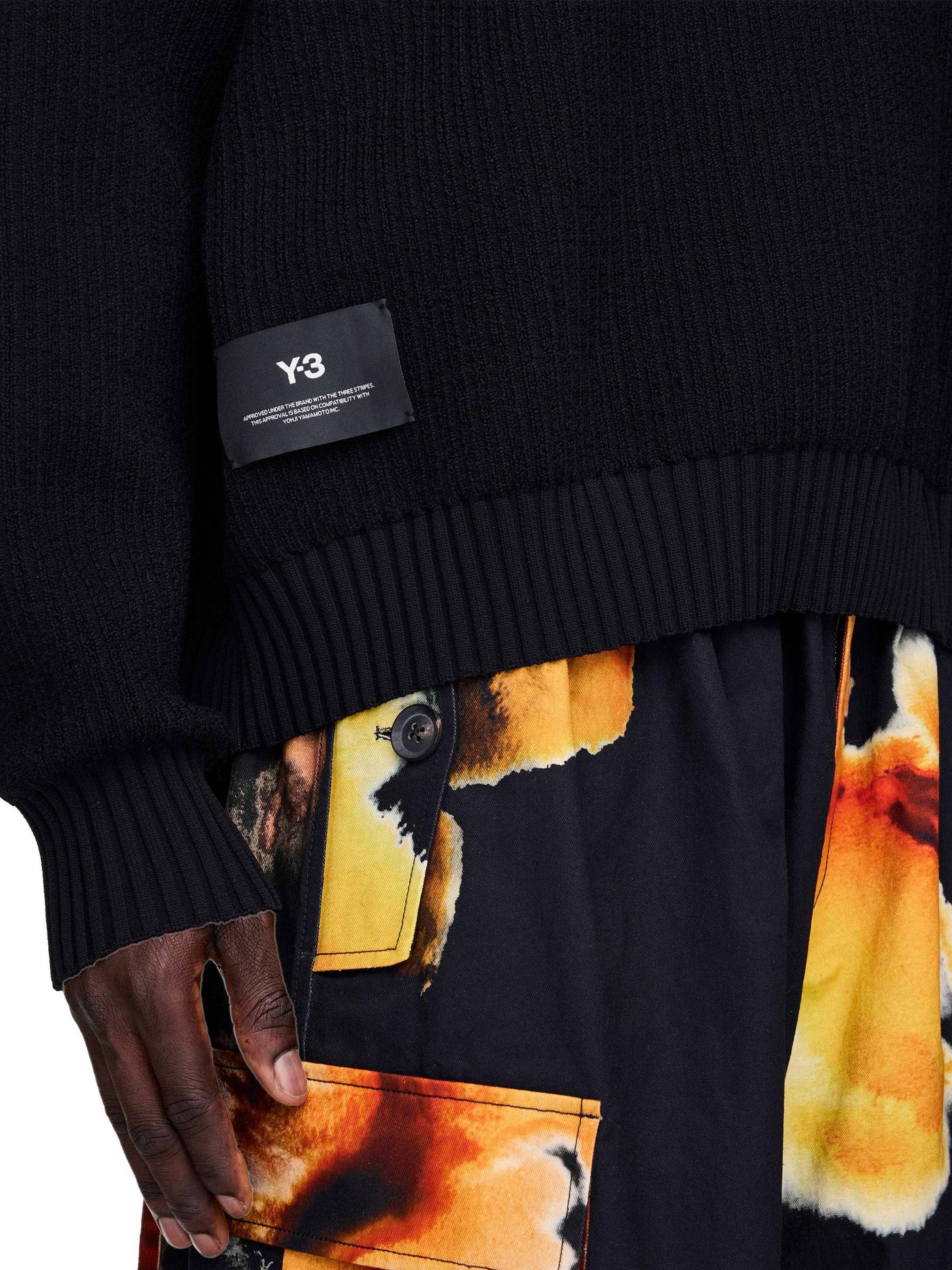 Black sweater with Y-3 label worn by a person