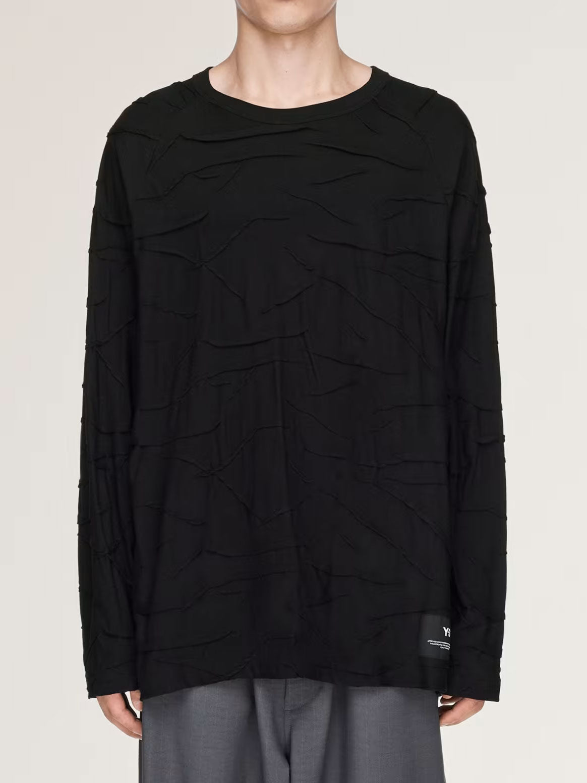 Model wearing the Y-3 Platform Oversized Long Sleeve Tee, showing its relaxed oversized silhouette, round neckline and long sleeves.