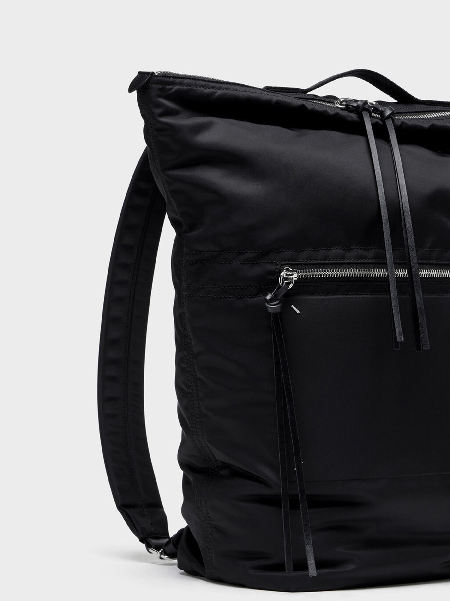 Maison Margiela Zip Line Backpack in Black angled back view with top handle
